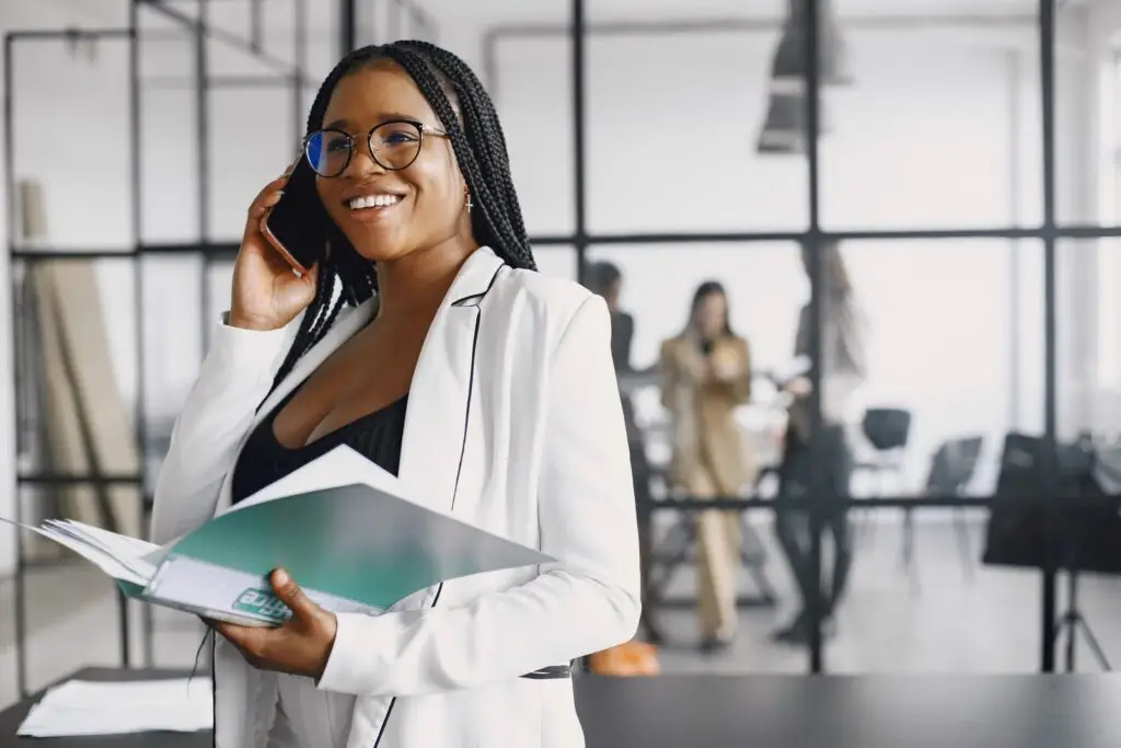 Professional on a phone call with a client, holding a folder